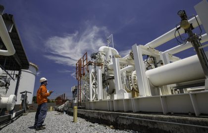 Male worker inspection at steel long pipes and pipe elbow in station oil factory during refinery valve of visual check record pipeline oil and gas industry